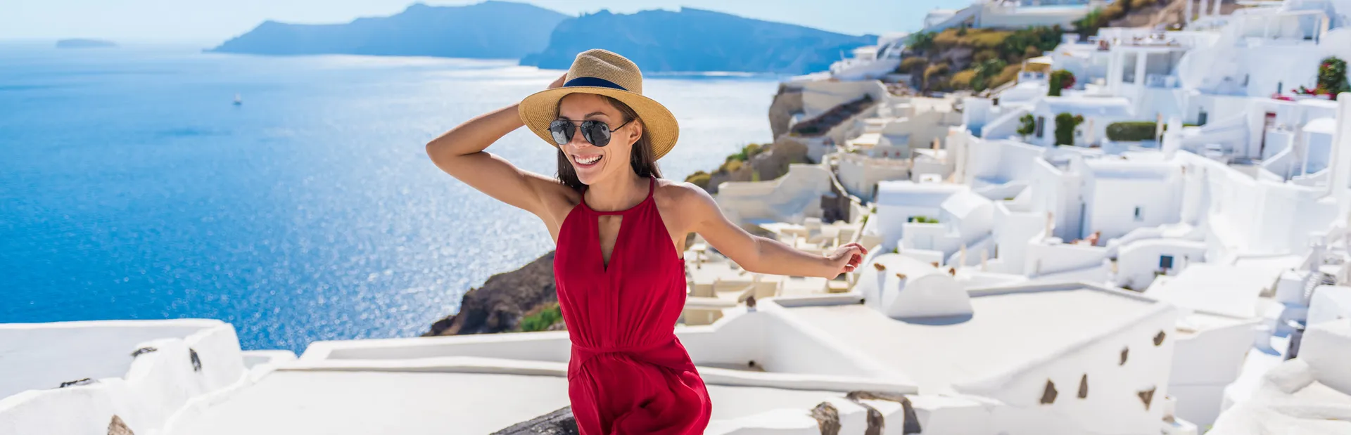 Woman running up stepps in Oia, Santorini in Greece