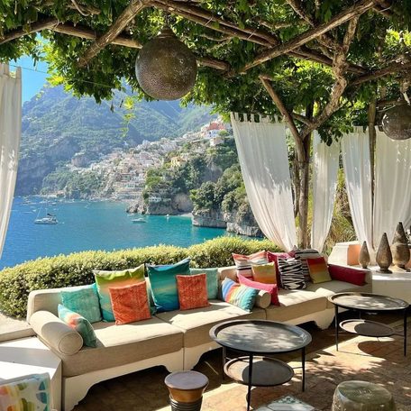 Alfresco seating area with cream sofa and canopy along the Amalfi Coast