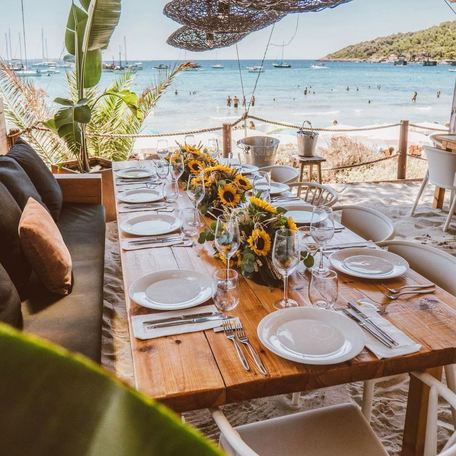 A long table set for a meal at Beso Beach