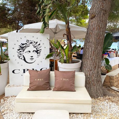 Cala Bassa sign and seating with brown cushions