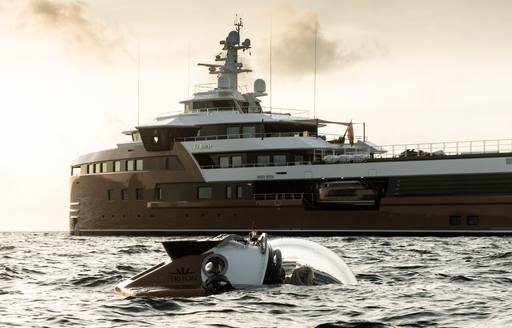 Charter yacht LA DATCHA surrounded by sea with a Triton 1650/3 submarine in the foreground