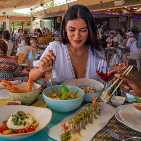 Guest trying Mediterranean and Japanese dishes from Tanit's varied menu