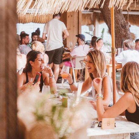 Charter guests enjoying drinks at Beso Beach Ibiza