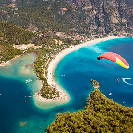 Elevated view looking down on a hang glider along the Turkish coast